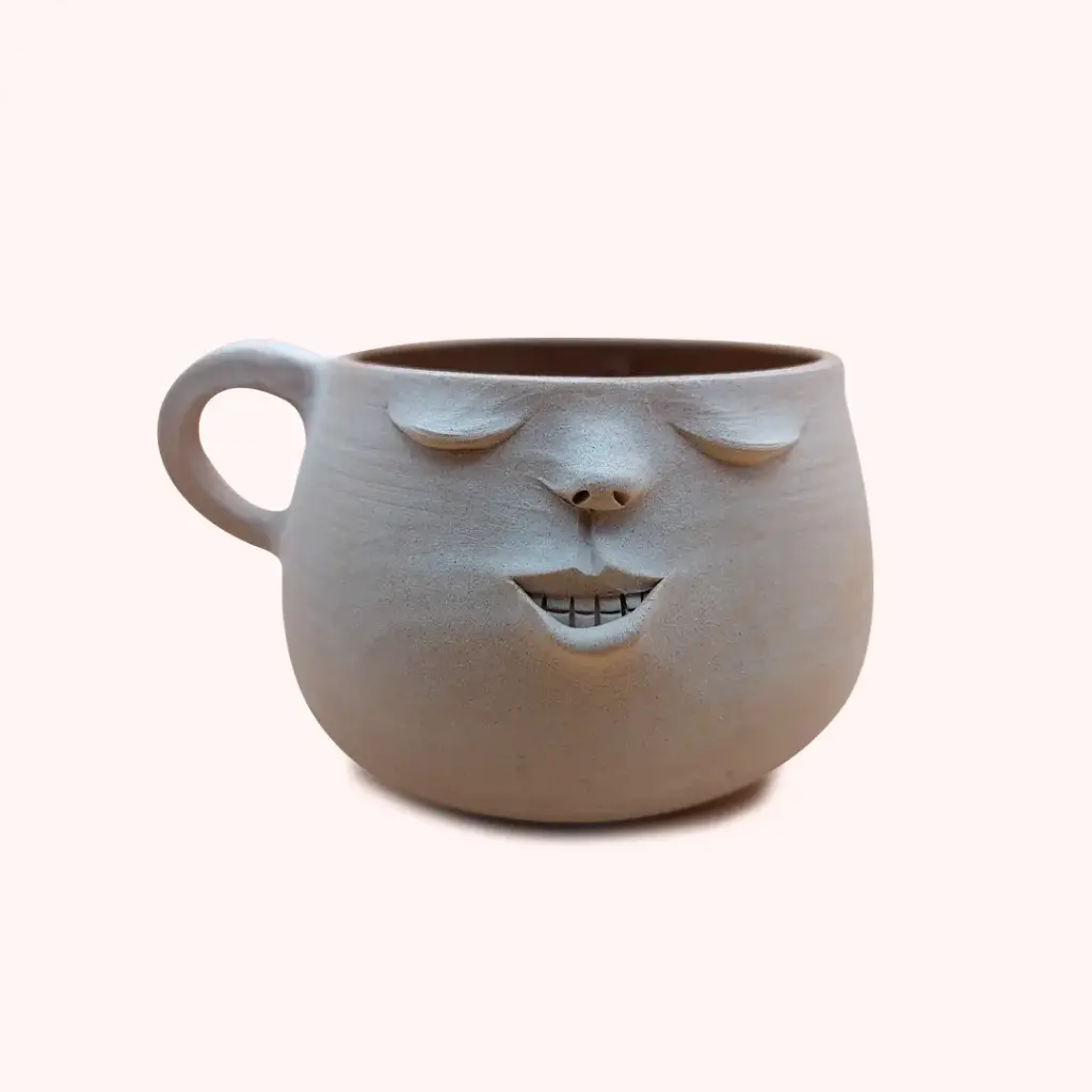 Tasse visage avec anse